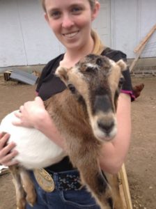 Goat and girl, smiling